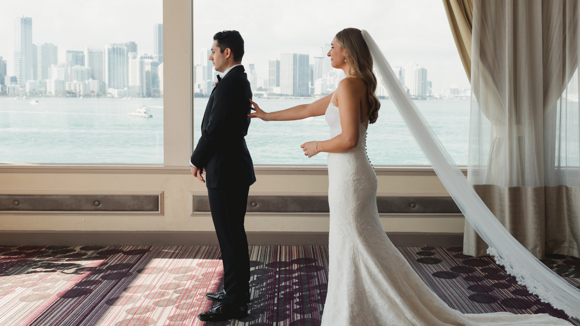 Bride trying on a designer wedding dress during a private bridal appointment at SAYES Miami in Coral Gables