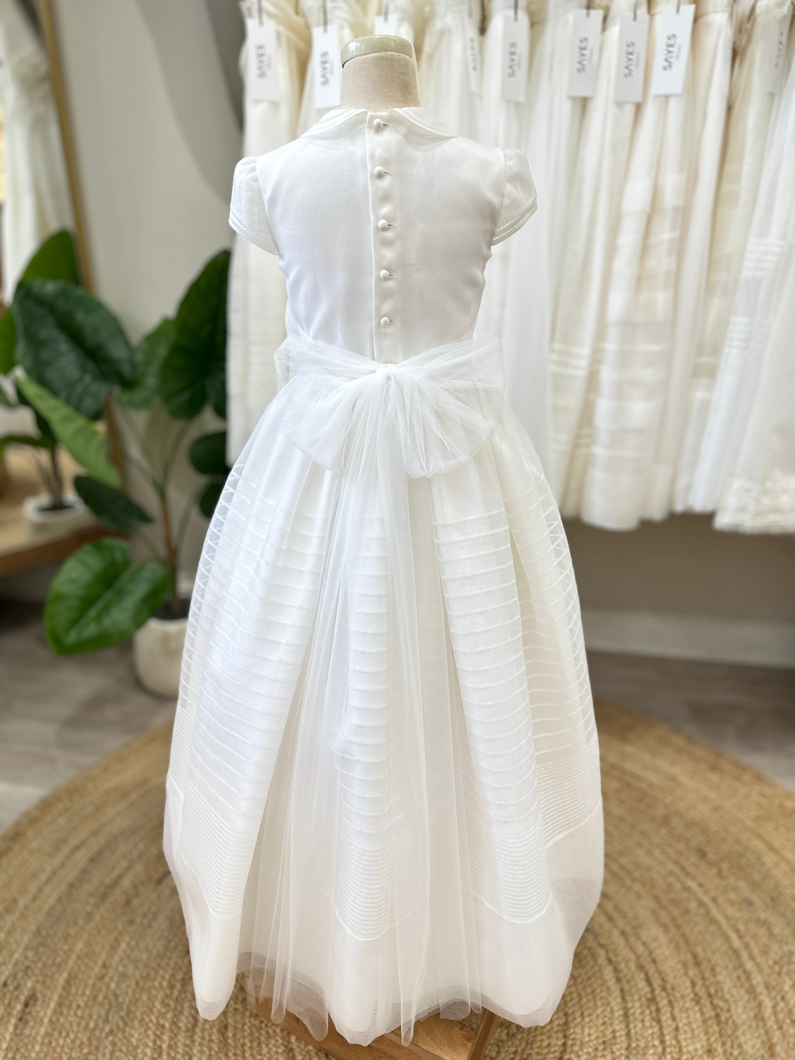 Classic Communion dress R140 featuring refined waist detail and flowing skirt